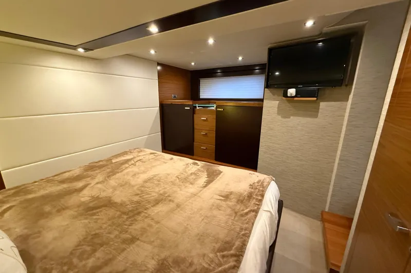  Yacht Photos Pics Luxurious bedroom interior of 2016 Tiara Yachts 50 Coupe with modern amenities.