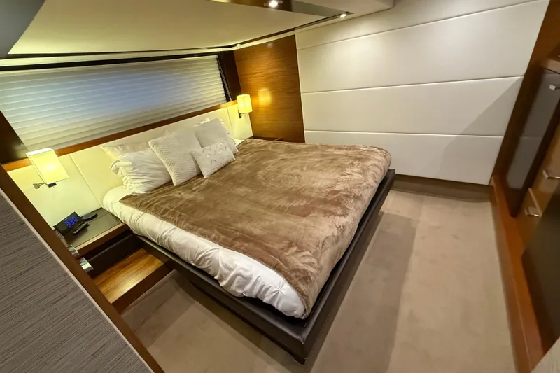  Yacht Photos Pics Luxurious bedroom interior of 2016 Tiara Yachts 50 Coupe with plush bedding and modern lighting.