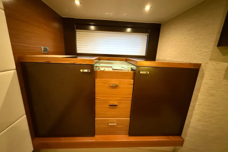  Yacht Photos Pics 2016 Tiara Yachts 50 Coupe interior with wooden cabinetry and modern design.
