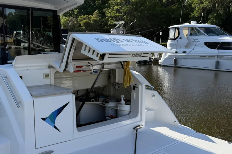  Yacht Photos Pics 2016 Tiara Yachts 50 Coupe docked, showcasing open storage compartment and sleek design.