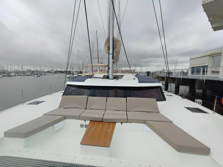  Yacht Photos Pics 2025 Fountaine Pajot Catamaran Aura 51 with spacious deck and seating, docked in marina.