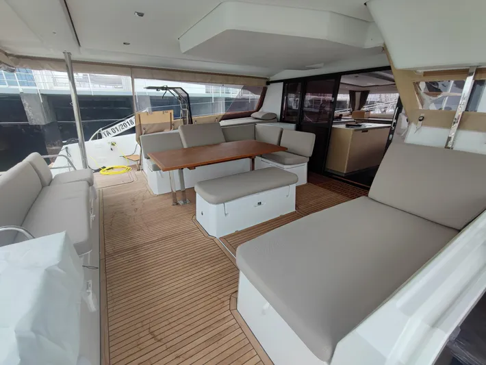  Yacht Photos Pics Spacious interior of 2025 Fountaine Pajot Catamaran Aura 51 with elegant seating and dining area.