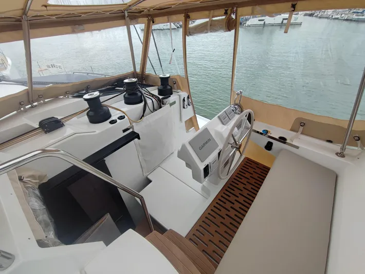  Yacht Photos Pics 2025 Fountaine Pajot Catamaran Aura 51 helm with Garmin navigation, docked at marina.