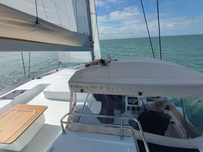  Yacht Photos Pics 2025 Fountaine Pajot Catamaran Aura 51 sailing on open sea under clear skies.