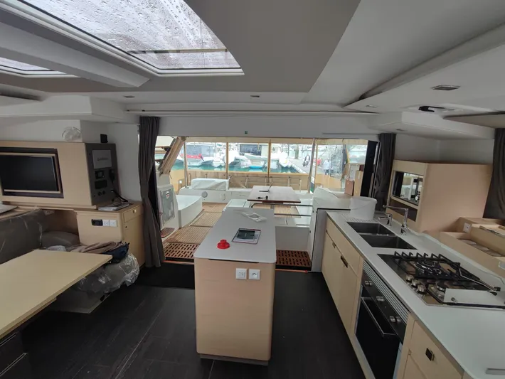 Yacht Photos Pics Interior of 2025 Fountaine Pajot Catamaran Aura 51, featuring modern kitchen and spacious living area.