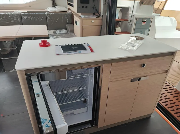  Yacht Photos Pics Modern kitchen interior of 2025 Fountaine Pajot Catamaran Aura 51 with open fridge.