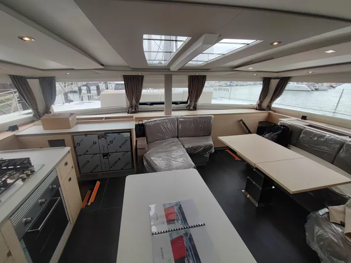 Yacht Photos Pics Luxurious interior of 2025 Fountaine Pajot Catamaran Aura 51 with modern furnishings and panoramic windows.