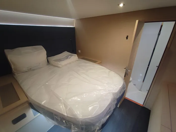  Yacht Photos Pics Luxurious bedroom in 2025 Fountaine Pajot Catamaran Aura 51, featuring modern design and cozy bedding.