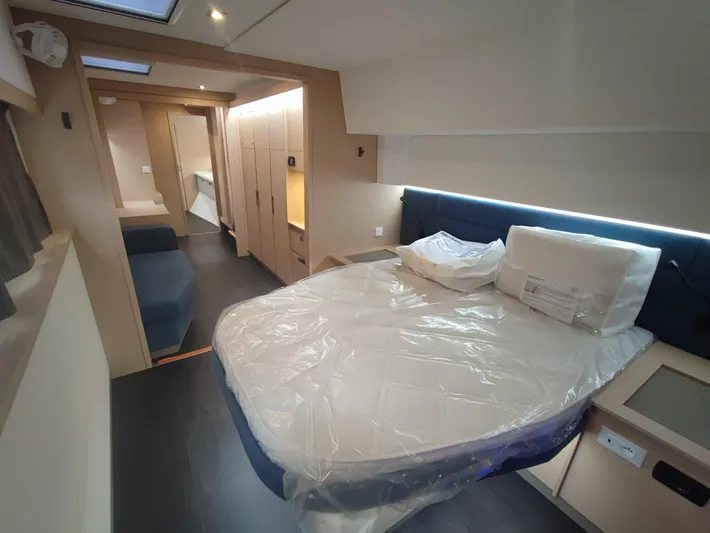  Yacht Photos Pics Luxurious bedroom interior of 2025 Fountaine Pajot Catamaran Aura 51 with modern furnishings.