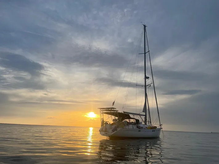 Layla Yacht Photos Pics Sailboat Beneteau Oceanis 461, 1997 model, at sunset on calm waters.