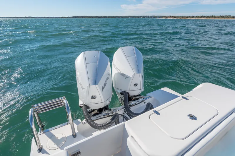  Yacht Photos Pics 2023 Contender 28 Sport boat with dual Mercury outboard engines on open water.