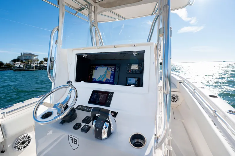  Yacht Photos Pics 2023 Contender 28 Sport boat dashboard with navigation system on open water.