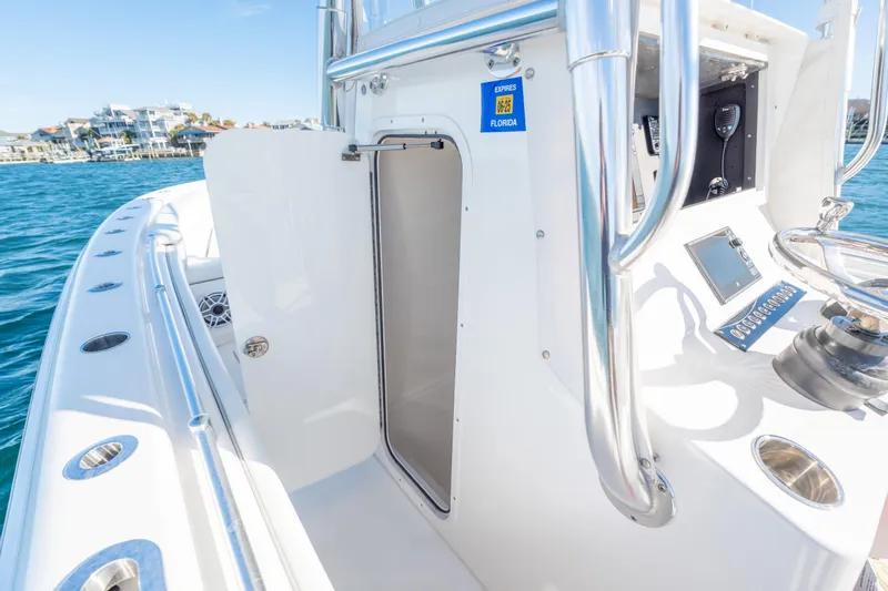  Yacht Photos Pics 2023 Contender 28 Sport boat interior with open cabin door, sleek design, and ocean view.
