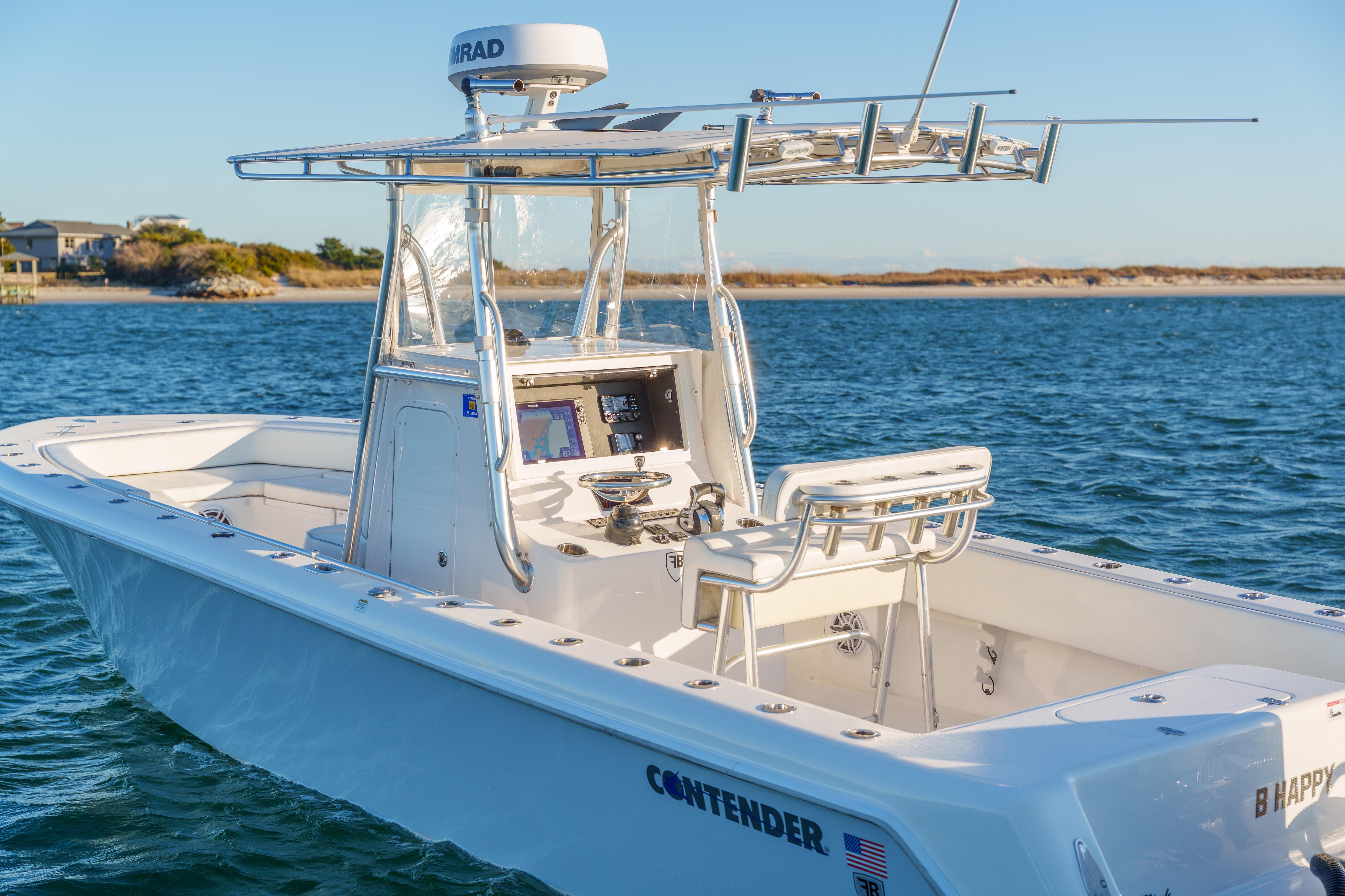 2023 Contender 28 Sport boat on water, featuring sleek design and advanced navigation equipment.