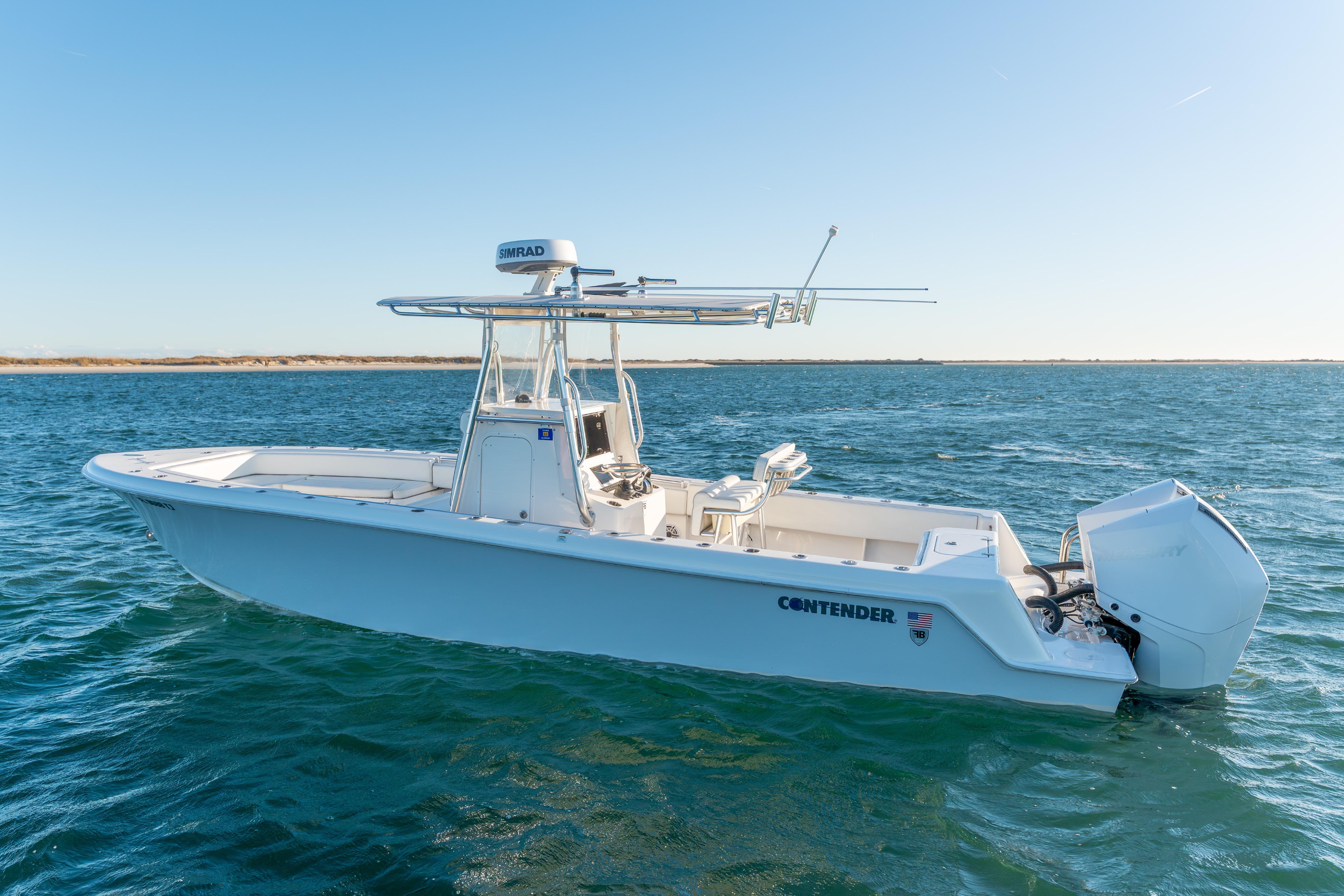 2023 Contender 28 Sport boat on open water, clear sky background.