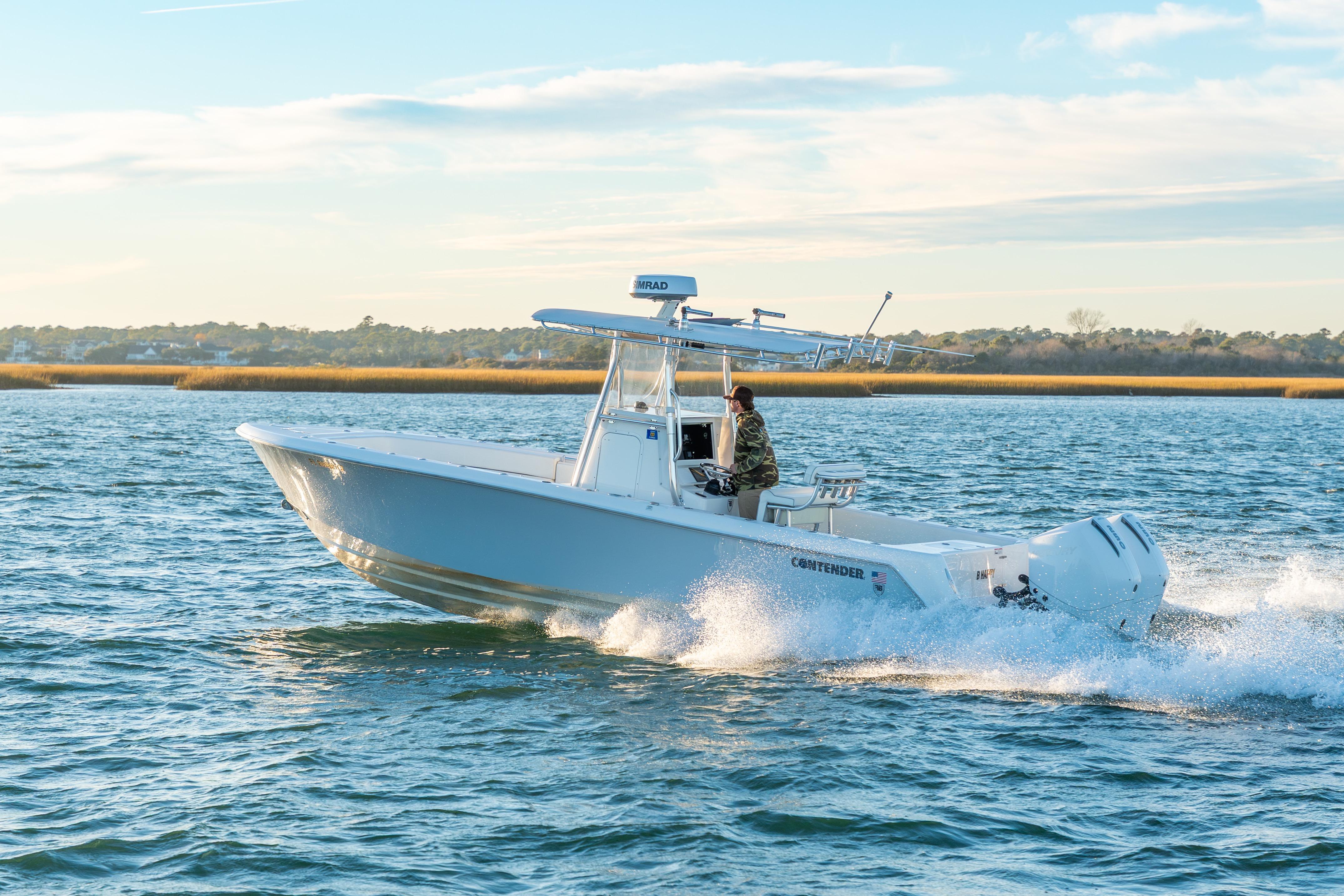 2023 Contender 28 Sport boat cruising on open water under a clear sky.