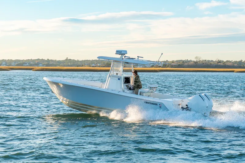  Yacht Photos Pics 2023 Contender 28 Sport boat cruising on open water under a clear sky.