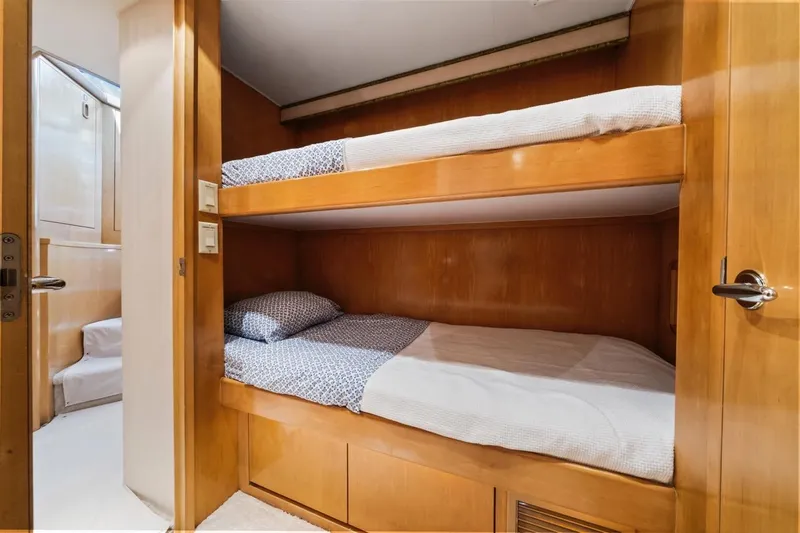  Yacht Photos Pics Bunk beds in 2000 Hatteras 74 Cockpit Motor Yacht cabin, featuring wooden interior.