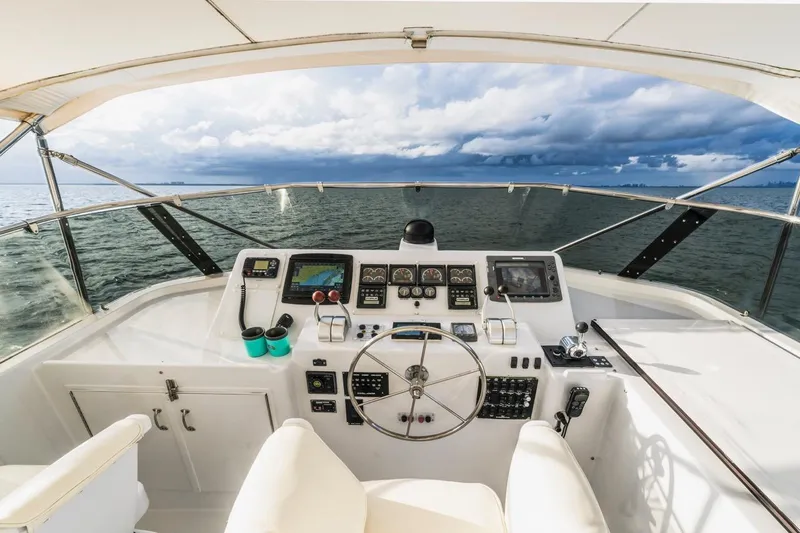  Yacht Photos Pics Cockpit view of 2000 Hatteras 74 Cockpit Motor Yacht with ocean and cloudy sky.