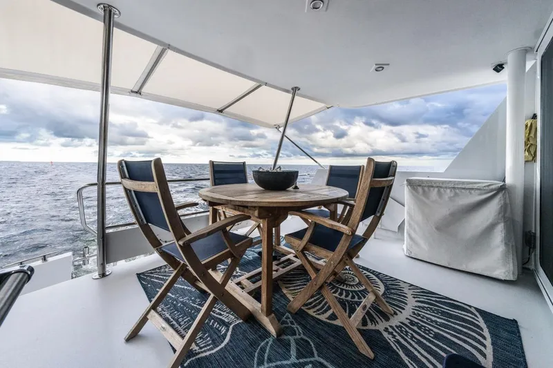  Yacht Photos Pics Outdoor dining area on 2000 Hatteras 74 Cockpit Motor Yacht with ocean view.