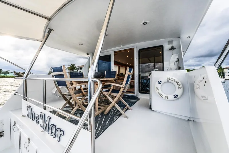  Yacht Photos Pics Luxurious 2000 Hatteras 74 Cockpit Motor Yacht with outdoor seating and ocean view.