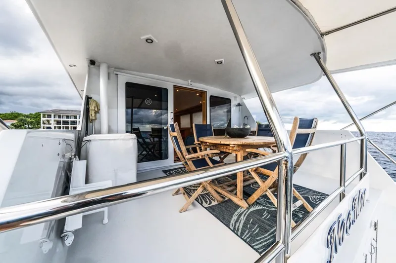  Yacht Photos Pics Hatteras 74 Cockpit Motor Yacht 2000, featuring outdoor seating and ocean view.