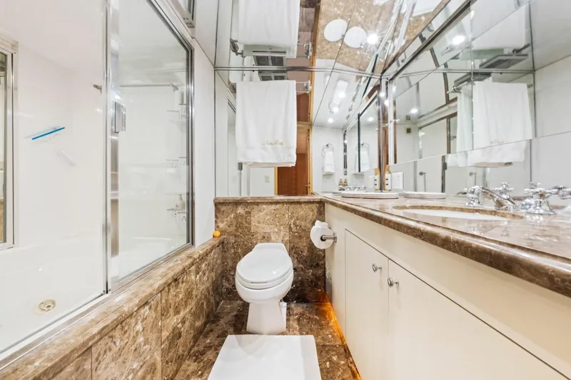  Yacht Photos Pics Luxurious bathroom in 2000 Hatteras 74 Cockpit Motor Yacht with marble accents.