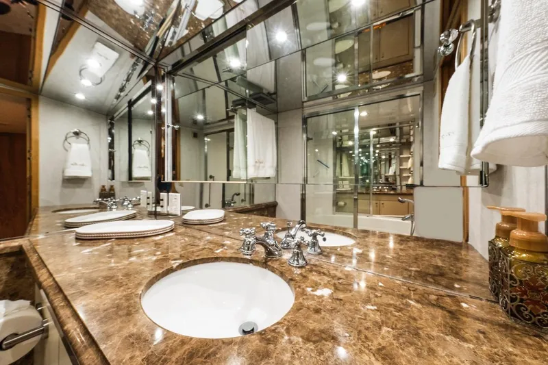  Yacht Photos Pics Luxurious bathroom in 2000 Hatteras 74 Cockpit Motor Yacht with marble countertop and elegant fixtures.