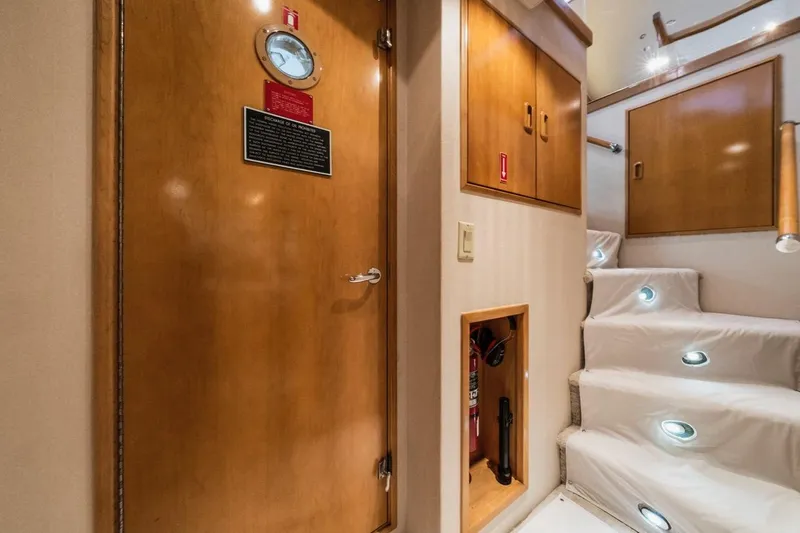  Yacht Photos Pics Interior of 2000 Hatteras 74 Cockpit Motor Yacht with wooden door and illuminated stairs.