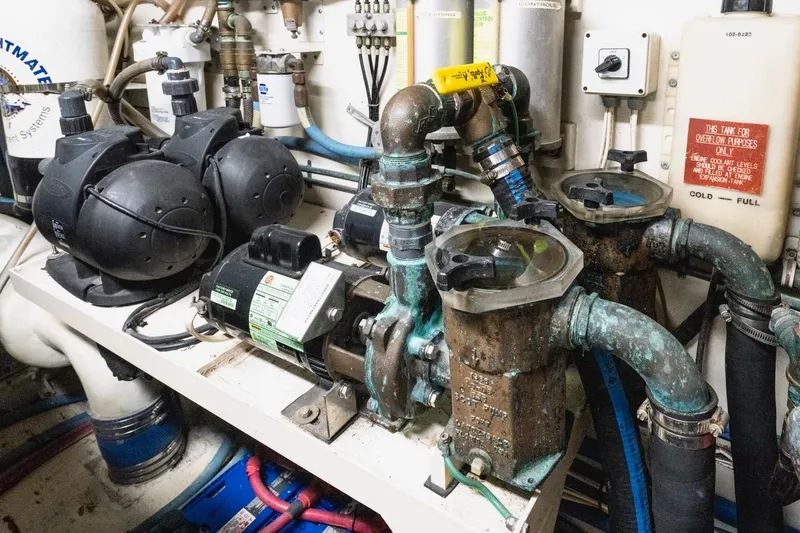  Yacht Photos Pics Engine room of 2000 Hatteras 74 Cockpit Motor Yacht with pumps and piping.