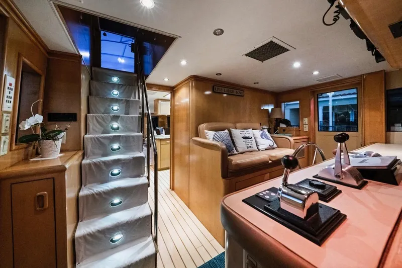  Yacht Photos Pics Luxurious interior of 2000 Hatteras 74 Cockpit Motor Yacht with elegant lighting and cozy seating.