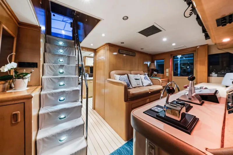  Yacht Photos Pics Luxurious interior of 2000 Hatteras 74 Cockpit Motor Yacht with modern helm and cozy seating.