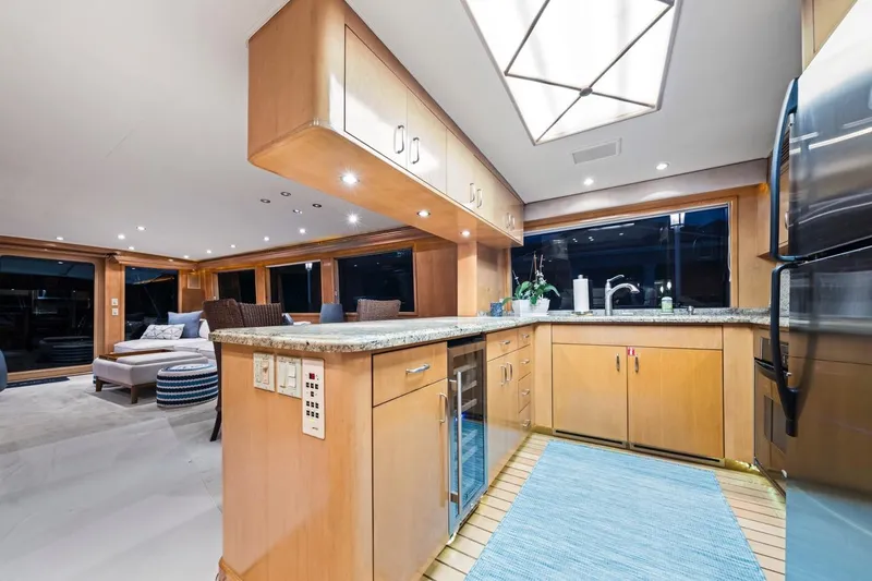  Yacht Photos Pics Luxurious interior of 2000 Hatteras 74 Cockpit Motor Yacht with modern kitchen and lounge area.