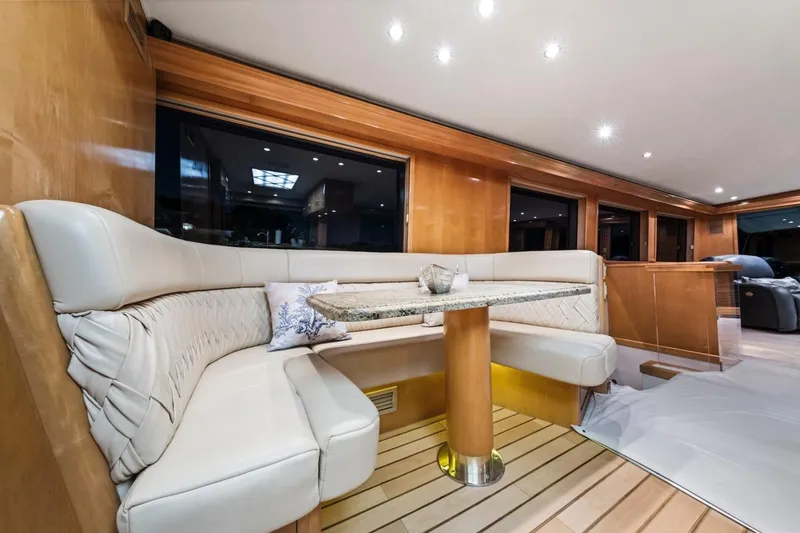  Yacht Photos Pics Luxurious interior of 2000 Hatteras 74 Cockpit Motor Yacht with elegant seating and table.