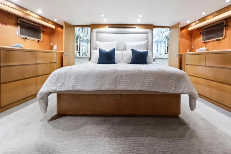  Yacht Photos Pics Luxurious bedroom interior of 2000 Hatteras 74 Cockpit Motor Yacht with elegant bedding.
