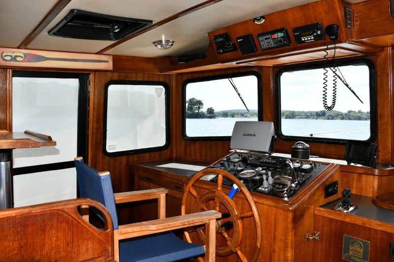 New Bearings Yacht Photos Pics Interior of 2000 Nordic Tug 42 Flybridge with wooden helm and navigation equipment.