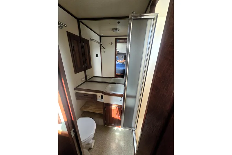 New Bearings Yacht Photos Pics Bathroom interior of 2000 Nordic Tug 42 Flybridge with shower and wooden cabinetry.
