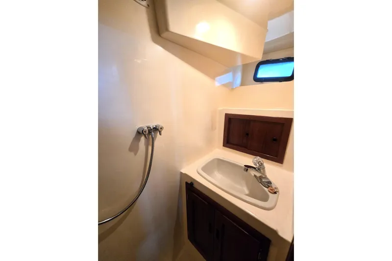 New Bearings Yacht Photos Pics Bathroom interior of 2000 Nordic Tug 42 Flybridge with sink and showerhead.