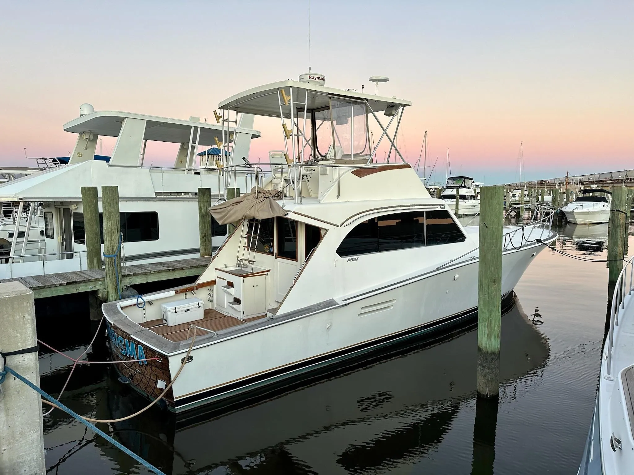 1987 Post 46 SPORT yacht docked at marina during sunset.