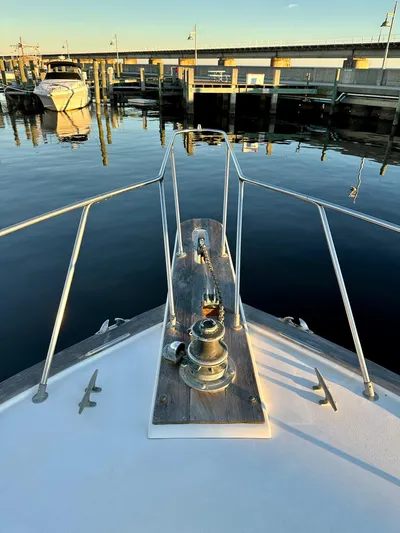 Charisma Yacht Photos Pics Bow of 1987 Post 46 SPORT yacht docked at marina, calm water reflections.