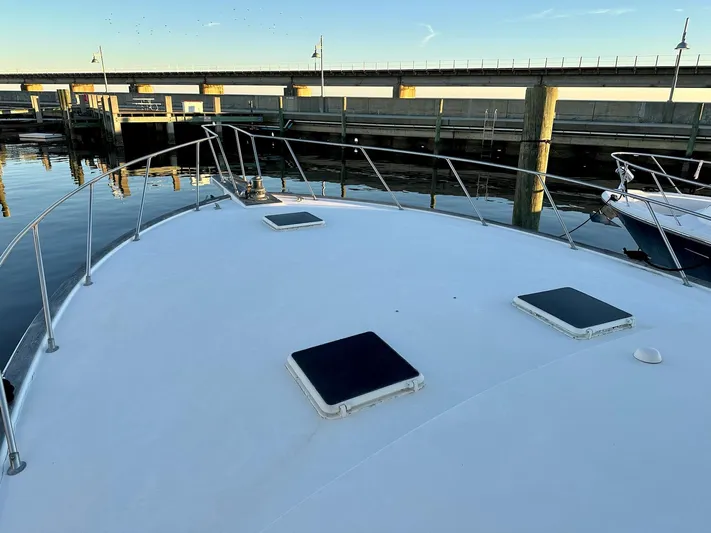 Charisma Yacht Photos Pics 1987 Post 46 SPORT yacht deck at marina, calm water, clear sky.