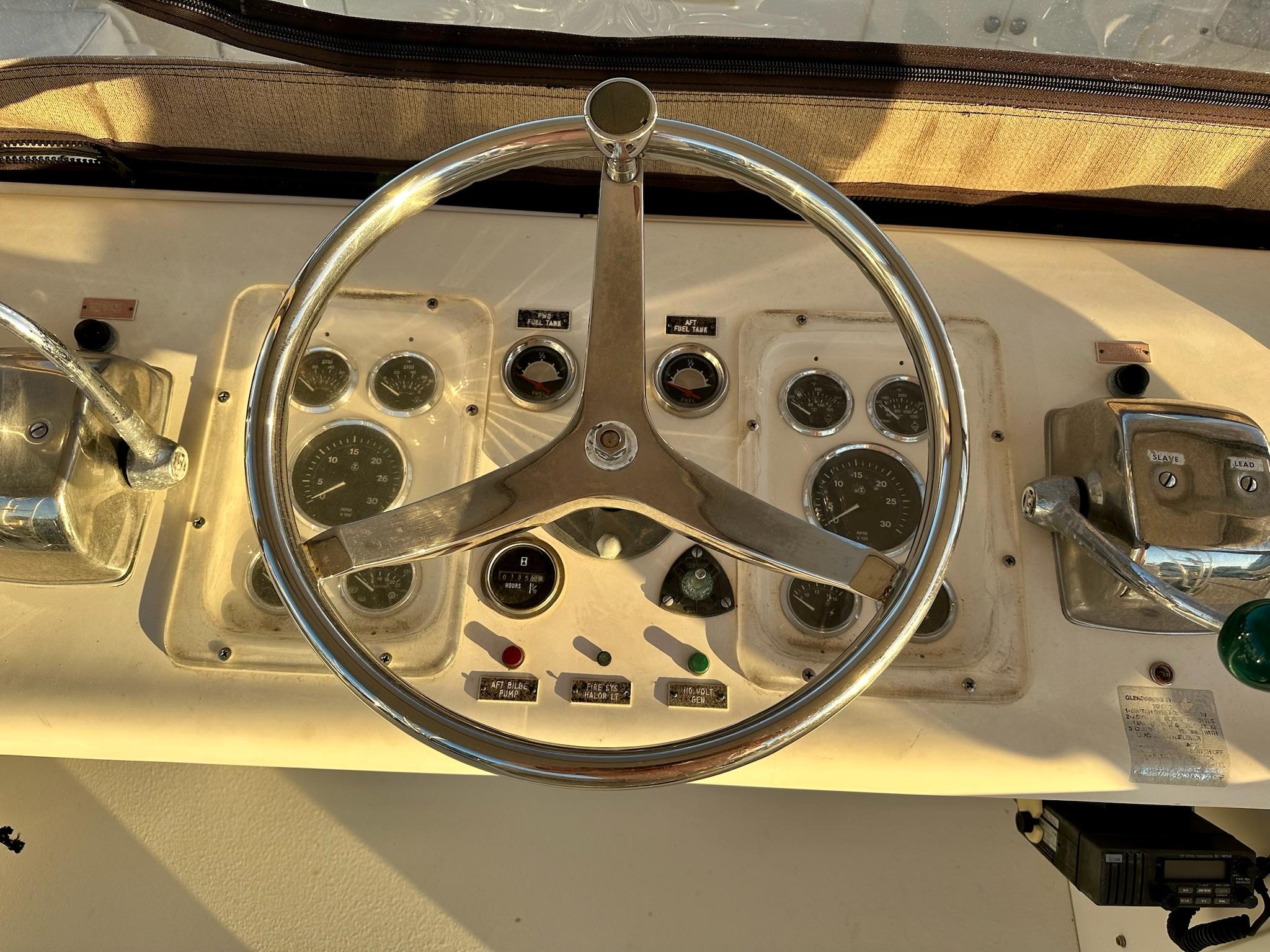 1987 Post 46 SPORT boat helm with steering wheel and control panel.