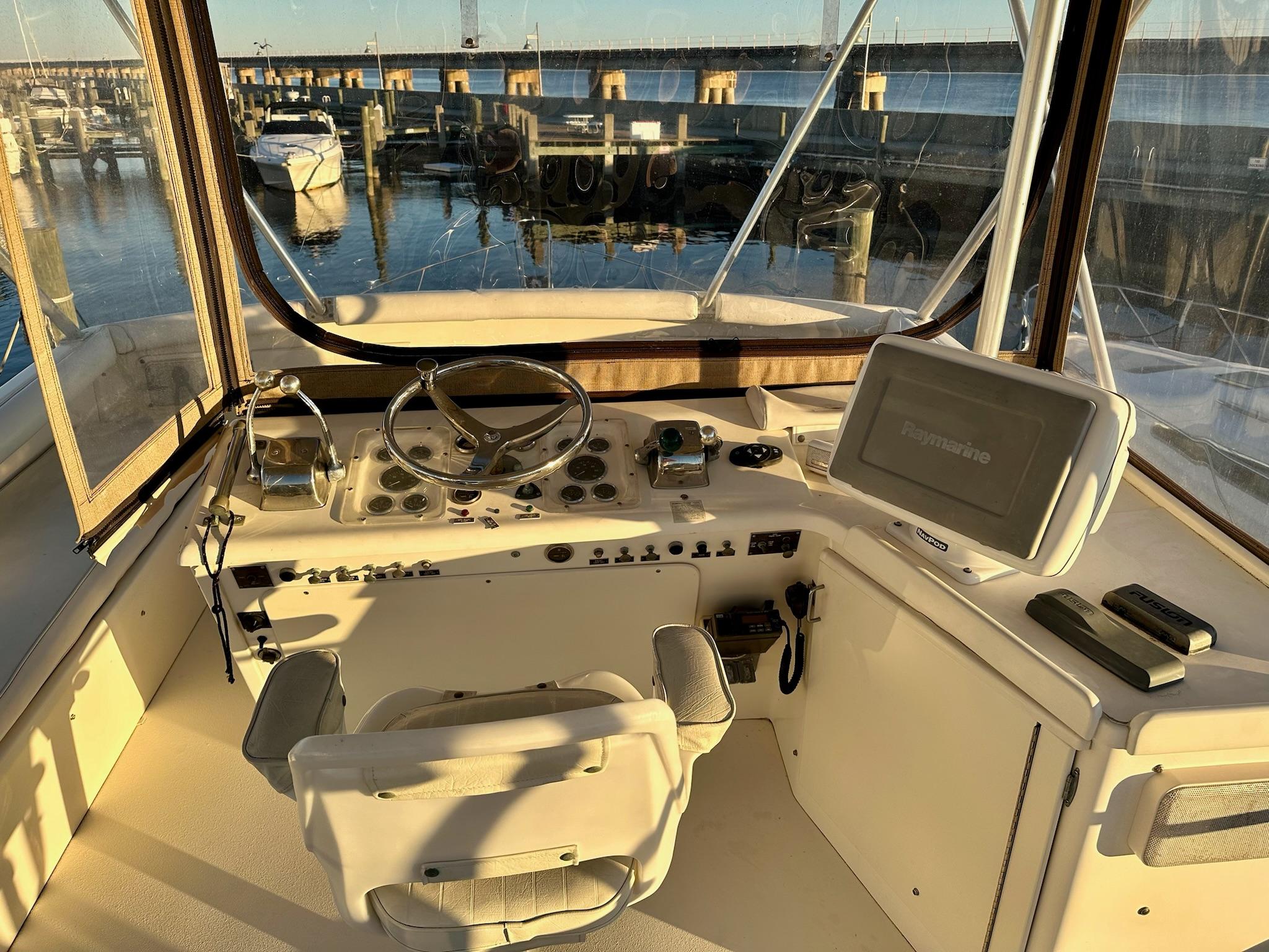 Helm of 1987 Post 46 SPORT yacht with steering wheel and navigation equipment.