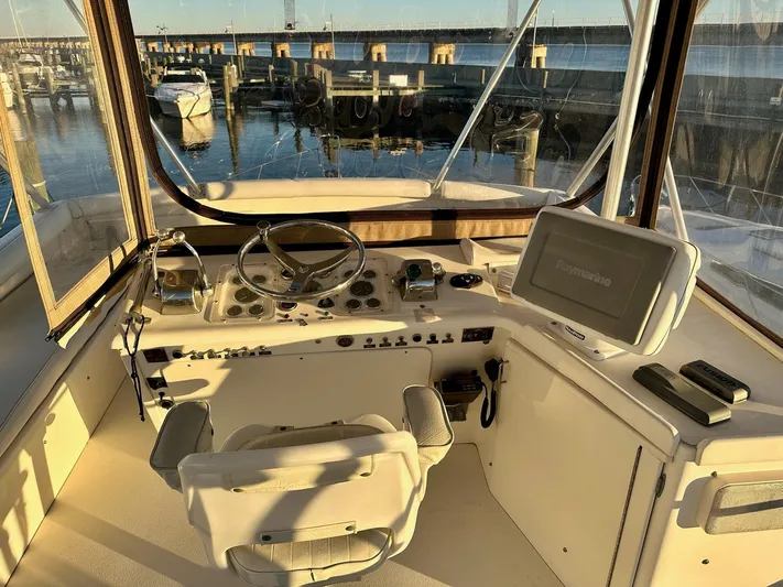 Charisma Yacht Photos Pics Helm of 1987 Post 46 SPORT yacht with steering wheel and navigation equipment.