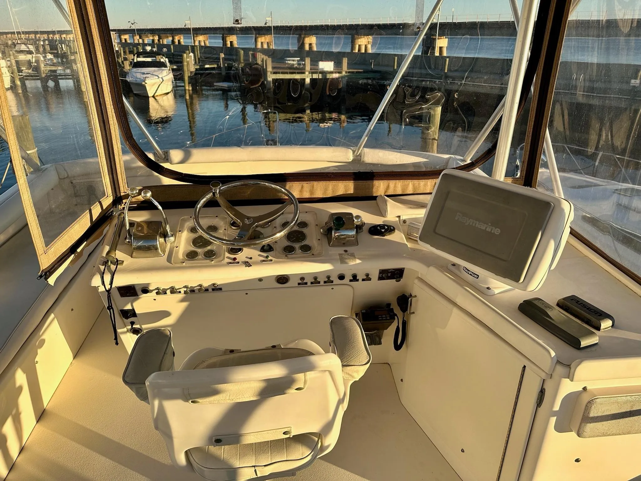 Helm of 1987 Post 46 SPORT yacht with steering wheel and navigation equipment.