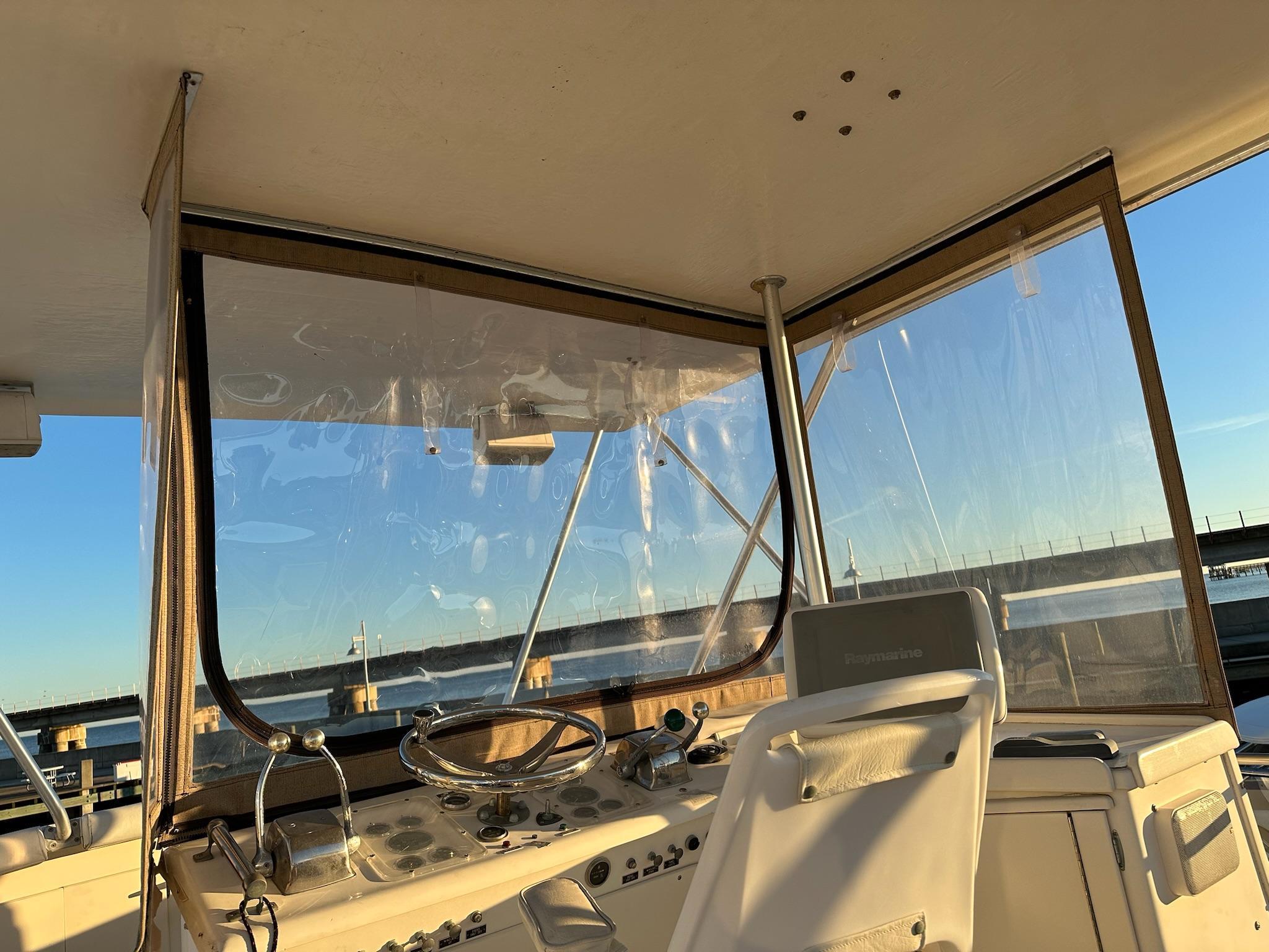 Interior view of 1987 Post 46 SPORT boat helm with clear windows and steering wheel.