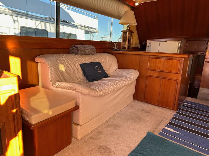 Charisma Yacht Photos Pics Interior of 1987 Post 46 SPORT yacht with cozy seating and wooden cabinetry.