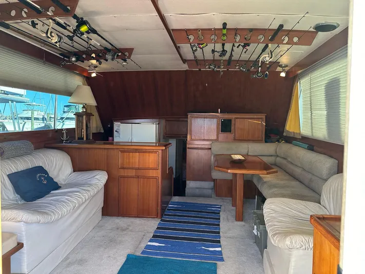 Charisma Yacht Photos Pics Interior of 1987 Post 46 SPORT yacht with fishing rods and cozy seating area.