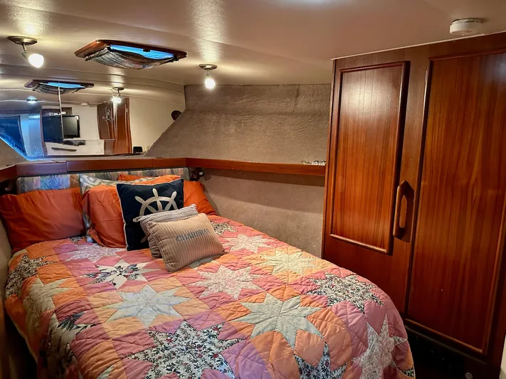 Charisma Yacht Photos Pics Cozy cabin interior of 1987 Post 46 SPORT yacht with colorful bedding and wooden cabinetry.