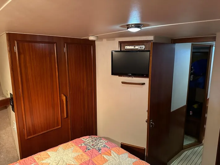 Charisma Yacht Photos Pics Cozy cabin interior of 1987 Post 46 SPORT yacht with TV and wooden cabinetry.